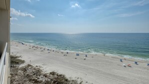 A beach view from a balcony with a clear sky, sandy beach, and ocean. - Beautiful 3 Br 3B Gulf Front With Free Wifi Tennis, Pickle Ball, 2 Pools (Orange Beach)