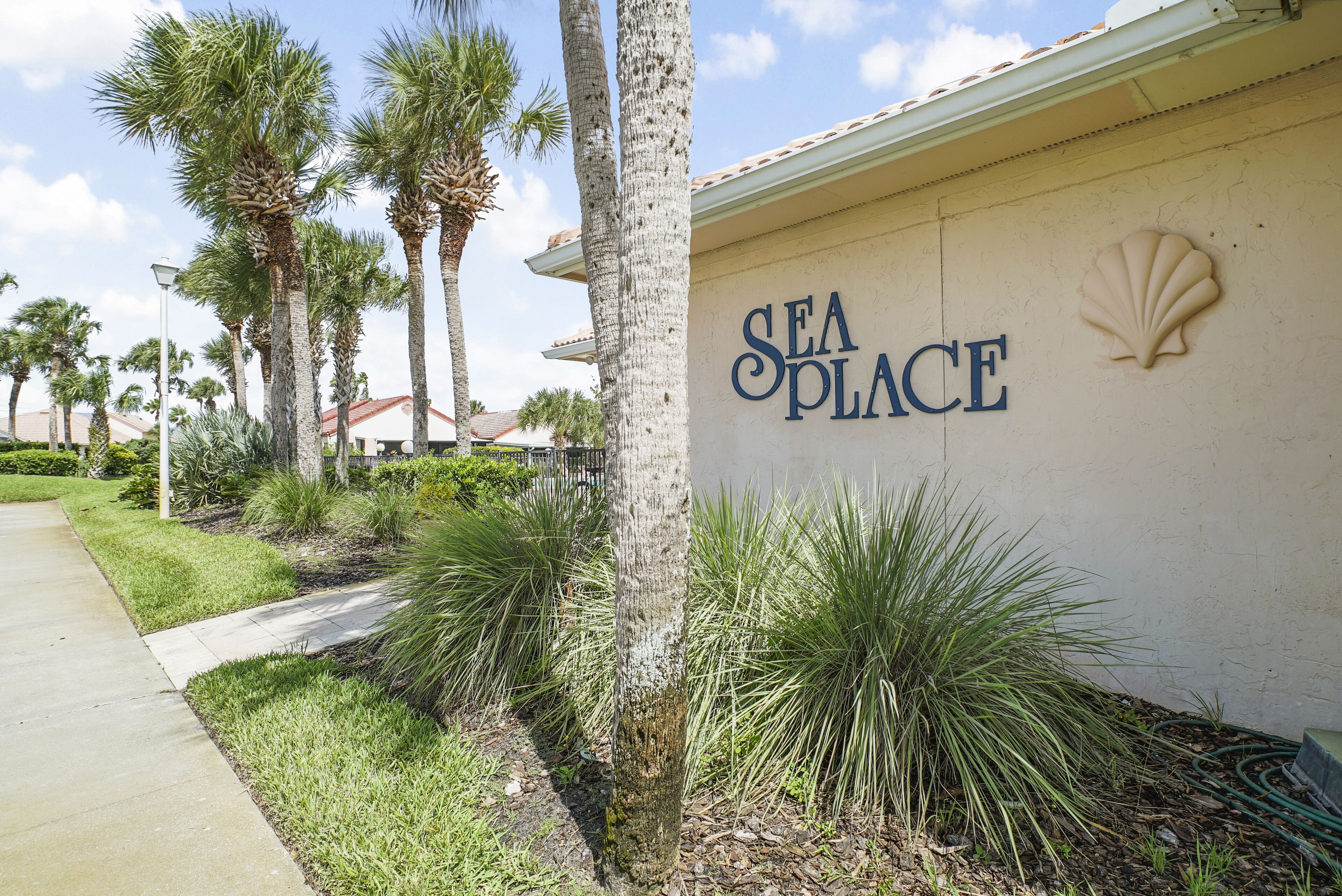 A building with a sign reading "SEA PLACE" and a shell emblem.