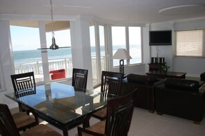 View of large living space, and beach balcony access