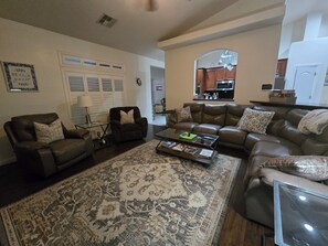 A living room with a sofa set, a coffee table, and a patterned rug. - Dandelion Court- Flower of the desert Near Death Valley & Praire Fire-Gun range (Pahrump)