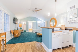 Cozy room with a kitchenette, dining area, and seating space.