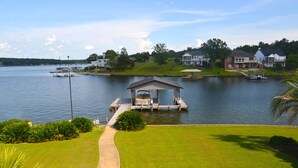 A lakeside property with a dock, a gazebo, and a well-maintained lawn. - Luxury Lakefront Estate! 6BR 4.5BA, Private Dock,Ramp, Lakeside Firepit & More! (Greenwood)