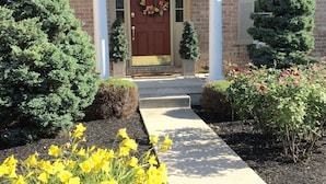 A brick building with a red door, a wreath, and a small tree in front. - Private Suite w/sitting room  in the heart of Brandywine Valley (Wilmington)