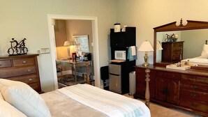 A bedroom with a bed, dresser, and a desk with a computer and lamp. - Private Suite w/sitting room  in the heart of Brandywine Valley (Wilmington)