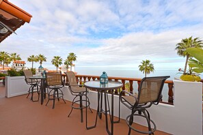 Relax on the balcony with a round table and four chairs, taking in the serene ocean view.