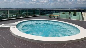 A rooftop pool with a bench, surrounded by a glass railing, overlooking a cityscape. - Residences at Daya by SR Home (Johor Bahru)
