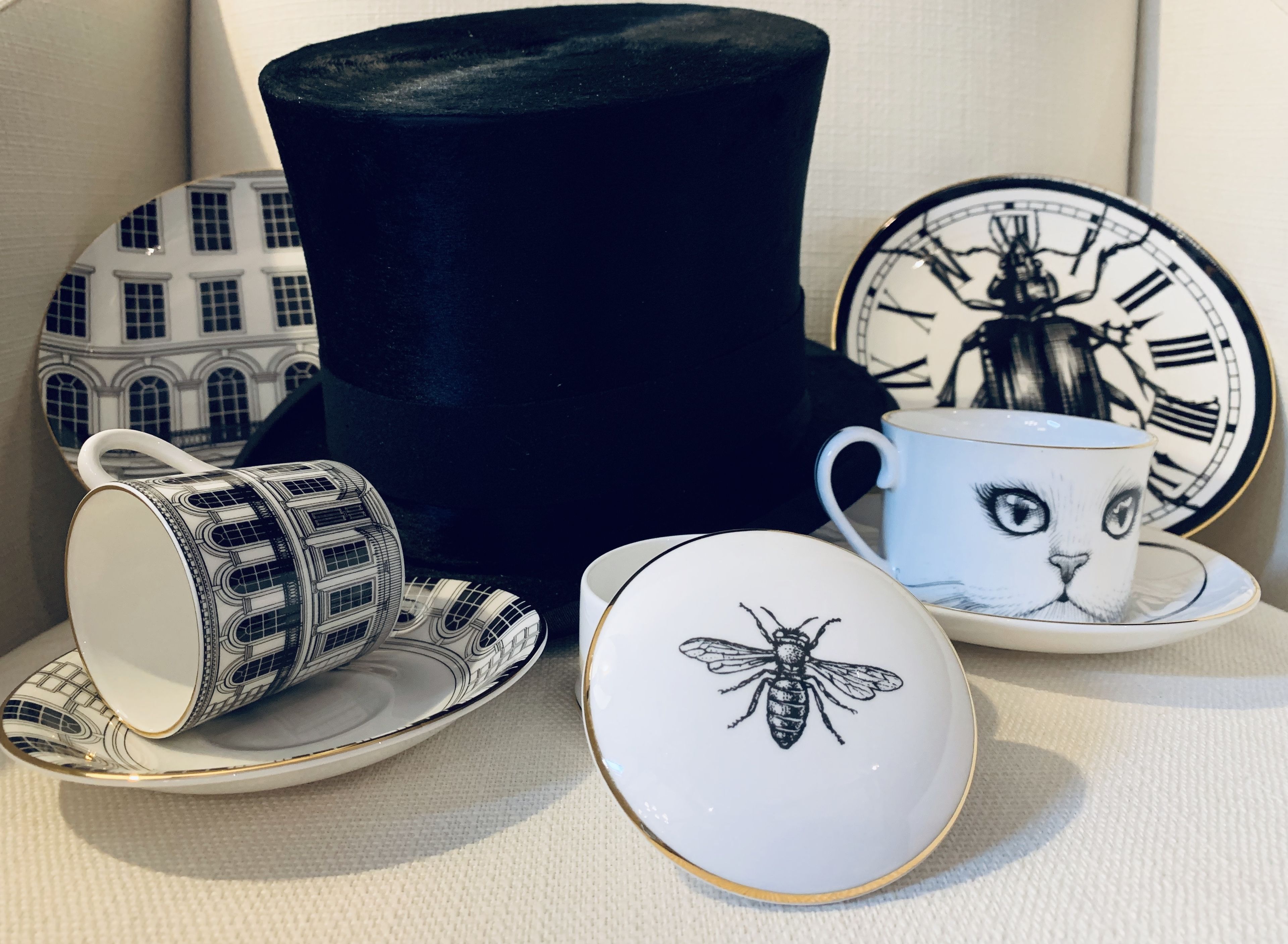 A collection of tableware including a mug, saucer, and plates with various designs.