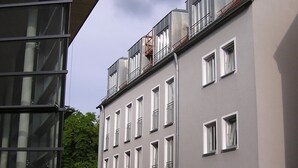 A hotel with a modern facade, multiple windows, and a sign indicating it is the Hotel Promenade. - Hotel zur Promenade (Donauwoerth)