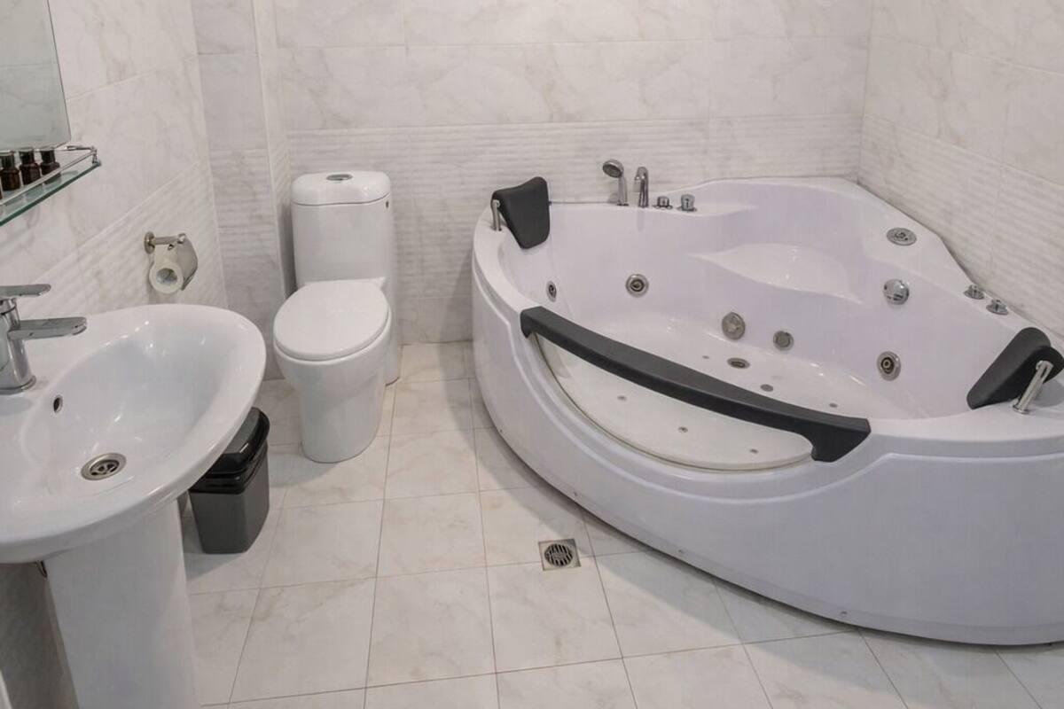 A modern bathroom with a freestanding bathtub, a toilet, and a sink.