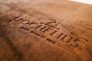 A close-up of a textured surface with the embossed text "JOCHELIS". - Bergresort Das JOCHELIUS (Nauders)
