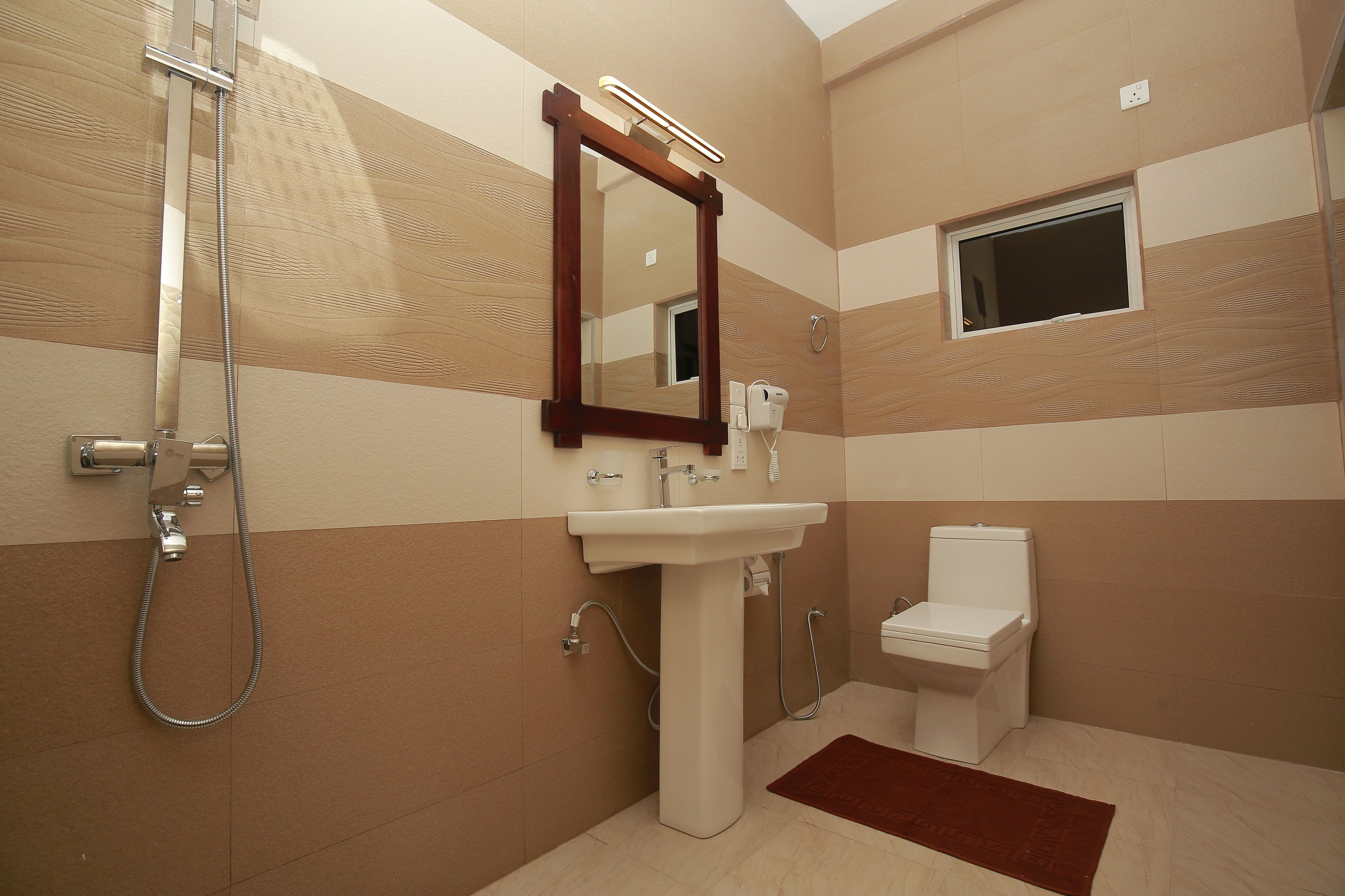 A bathroom with a shower, sink, and toilet.