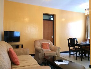 Relax in this cozy space with a flat-screen TV, comfortable sofa, and dining area.