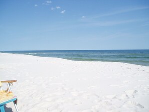 Relax on the wide, sandy beach with a gentle sea.