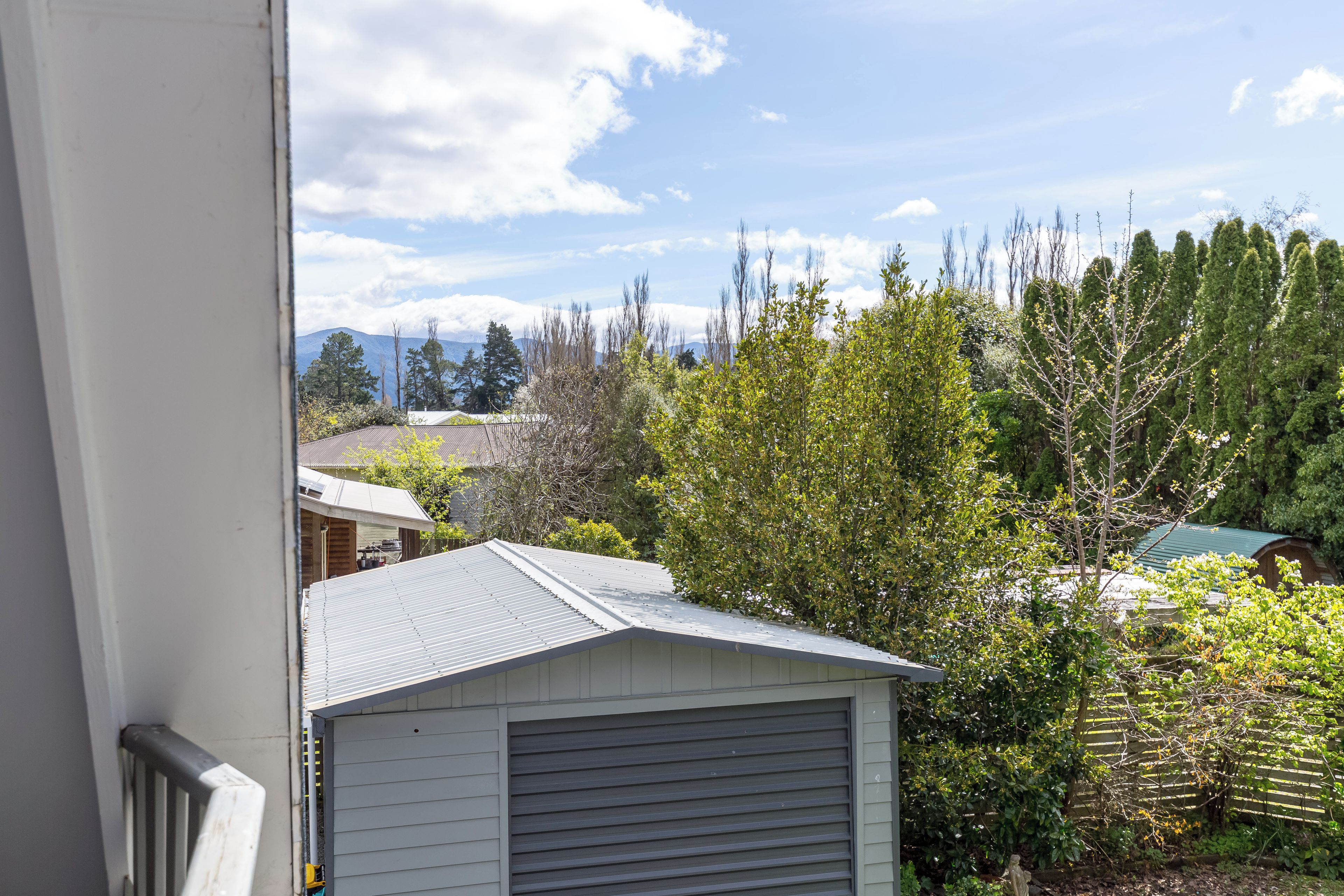 A residential area with a garage and a view of a mountain range.