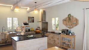 A modern kitchen with a central island, stainless steel appliances, and wooden accents. - House / Villa - Gordes (Gordes)