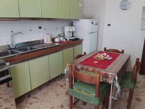 Fridge, coffee/tea maker, electric kettle, cookware/dishes/utensils