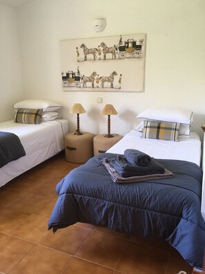 A bedroom with two single beds, a large bed, and a wall-mounted artwork of horses and carriages. - 4 bedrooms Villa with pool, Sea view - 3 min walk to Binibeca vell (Binibequer)