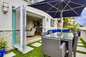 Relax on the patio with a glass-top table and wicker chairs under a shaded area.