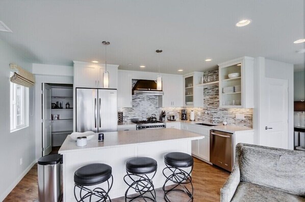 Enjoy cooking in this well-lit kitchen with a central island and stainless steel appliances.
