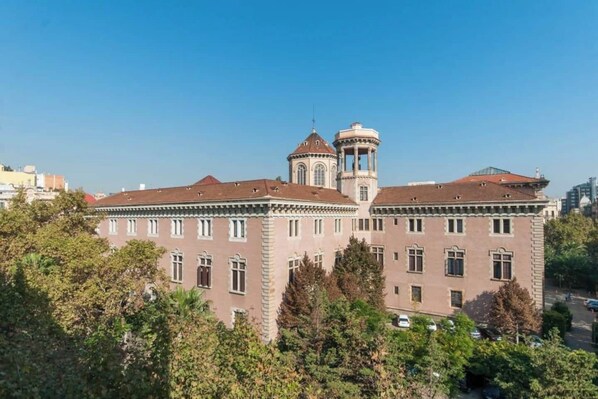 A large, historic building with a central tower and multiple windows.