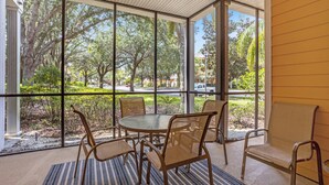 A room with a large window, a round table, and four chairs. - Bahama Bay, Davenport, Florida Oversize 2 Br condo (Davenport)