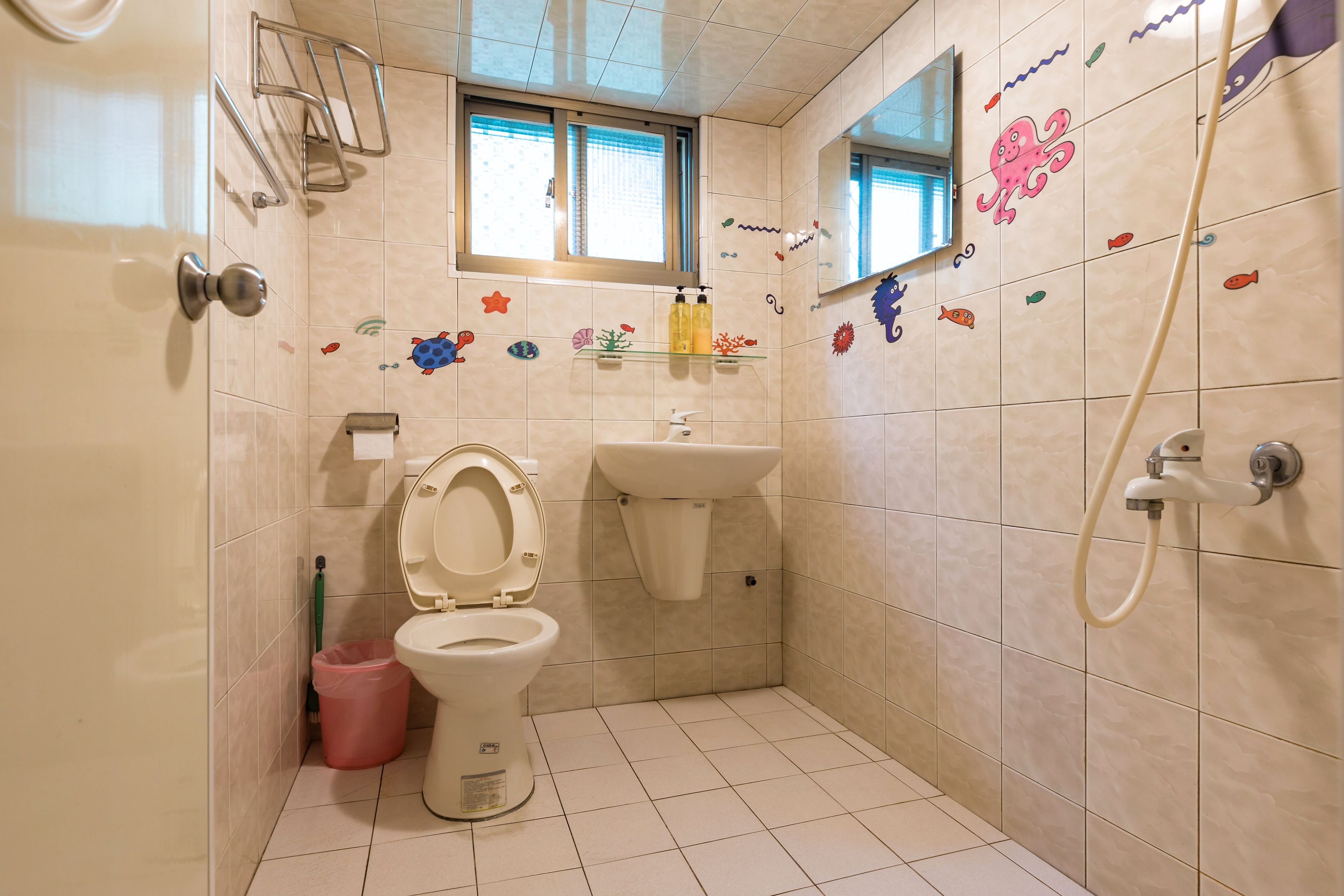 A bathroom with a toilet, sink, and shower.