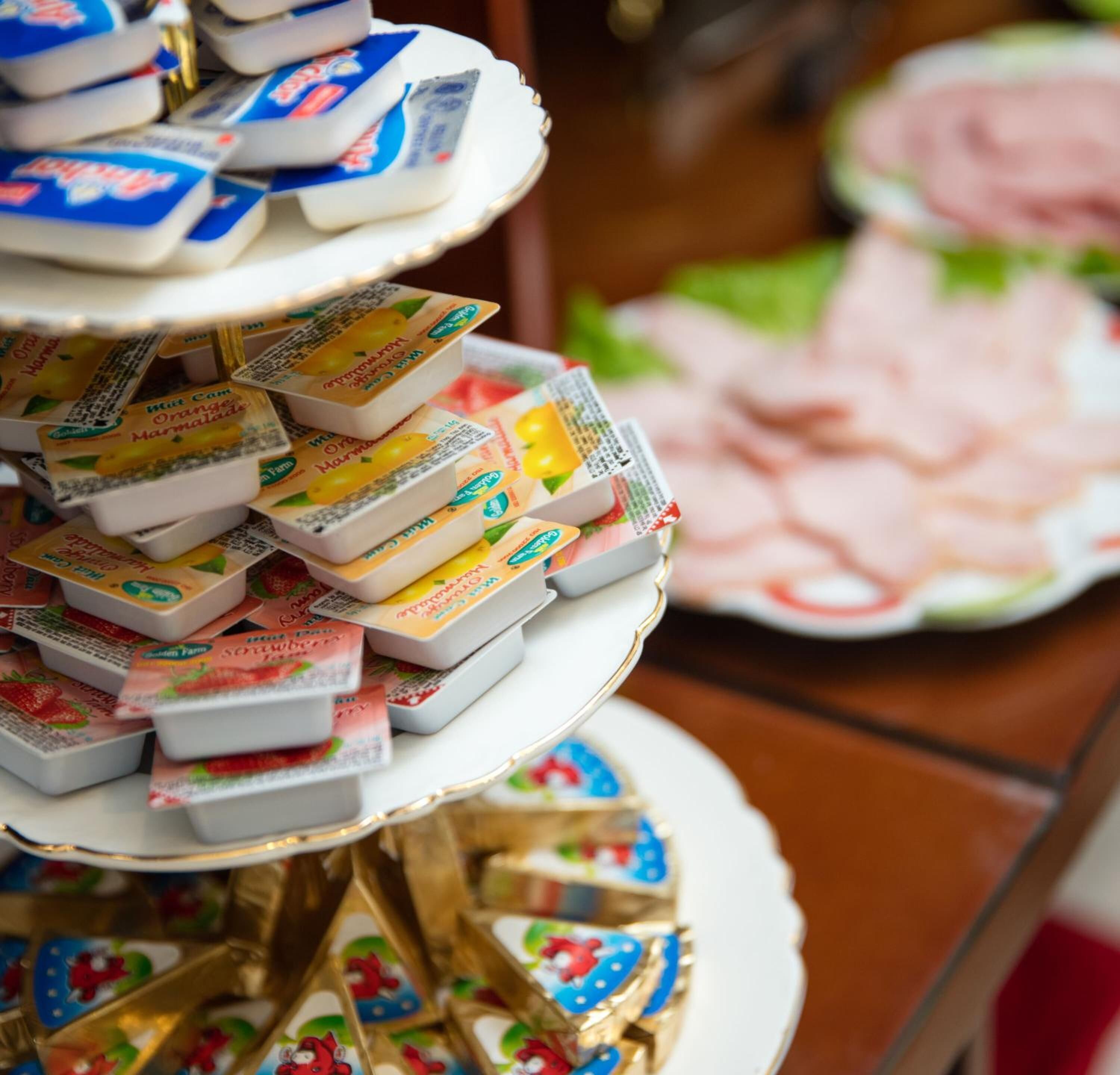 A multi-tiered display of packaged food items on a decorative stand.