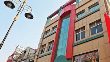Stylish building with a unique design, featuring multiple windows and a prominent sign.
