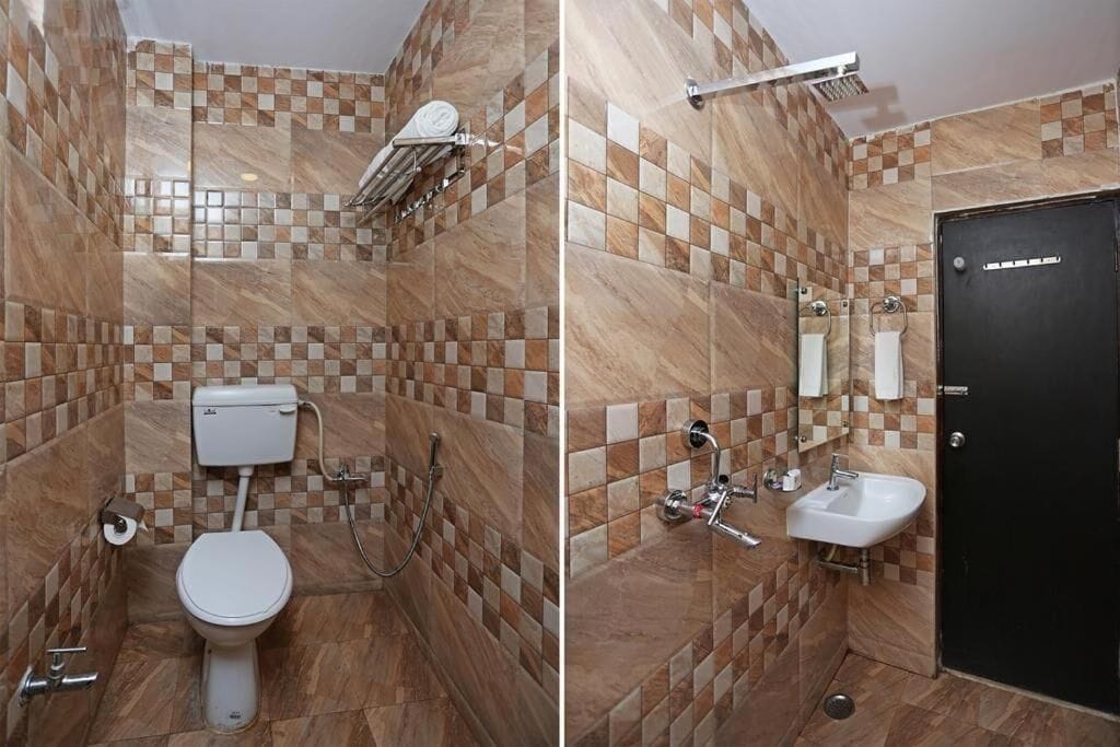 A bathroom with a toilet, shower, and sink.