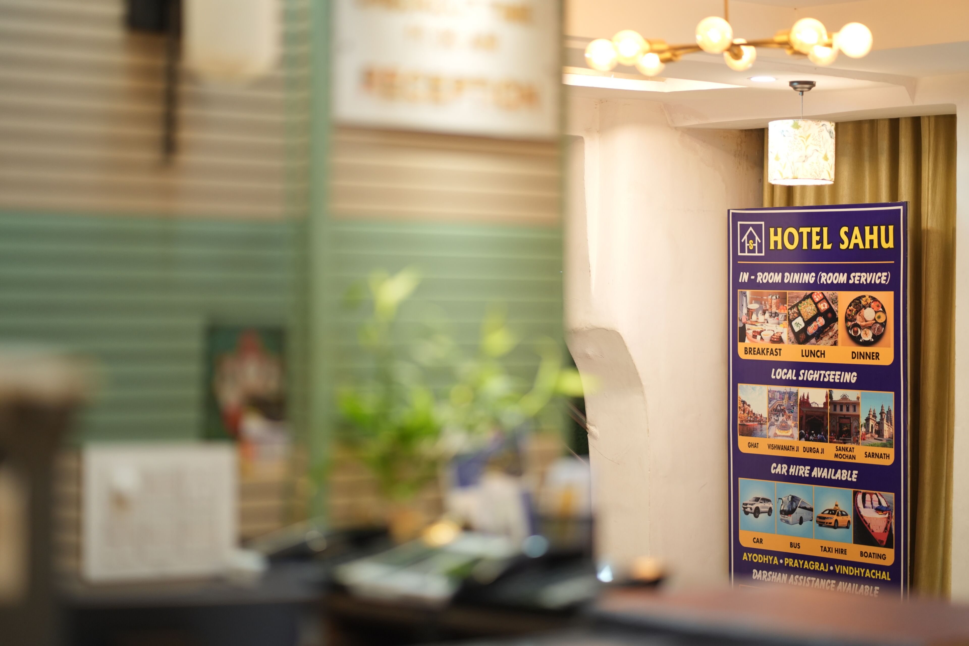 A hotel signboard with amenities like in-room dining, local sightseeing, and car hire options.