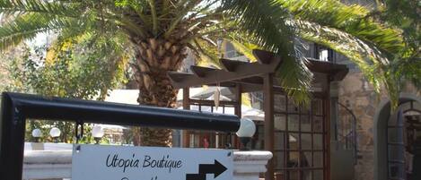 A sign indicating directions to 'Utopia Boutique Reception' and 'Standard Rooms' with arrows pointing to the right.