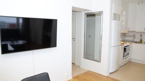 A modern kitchen with white cabinets, a built-in oven, and a refrigerator. - Fastliving Apartment Hotel (Vasteras)