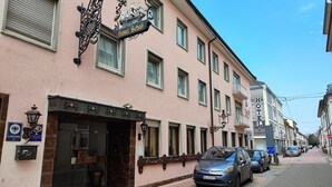 A hotel with a classic facade, a prominent sign, and a parked car in front. - Hotel Schiff (Rastatt)