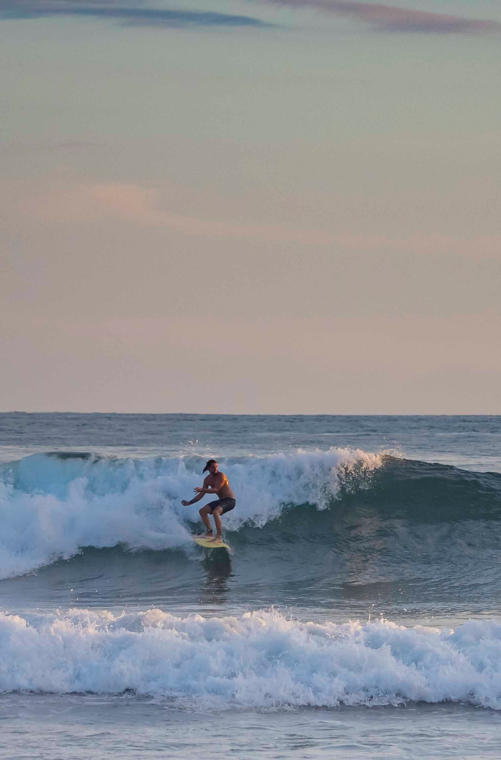 A surfer riding a wave in the ocean.