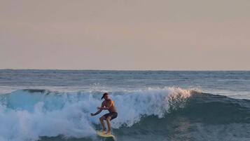 A surfer riding a wave in the ocean.