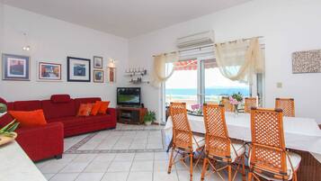 Exclusive Apartment, Multiple Beds, Non Smoking, Sea View | Living room | Flat-screen TV