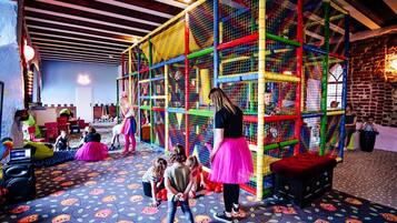 A play area with colorful net structures and a patterned floor.