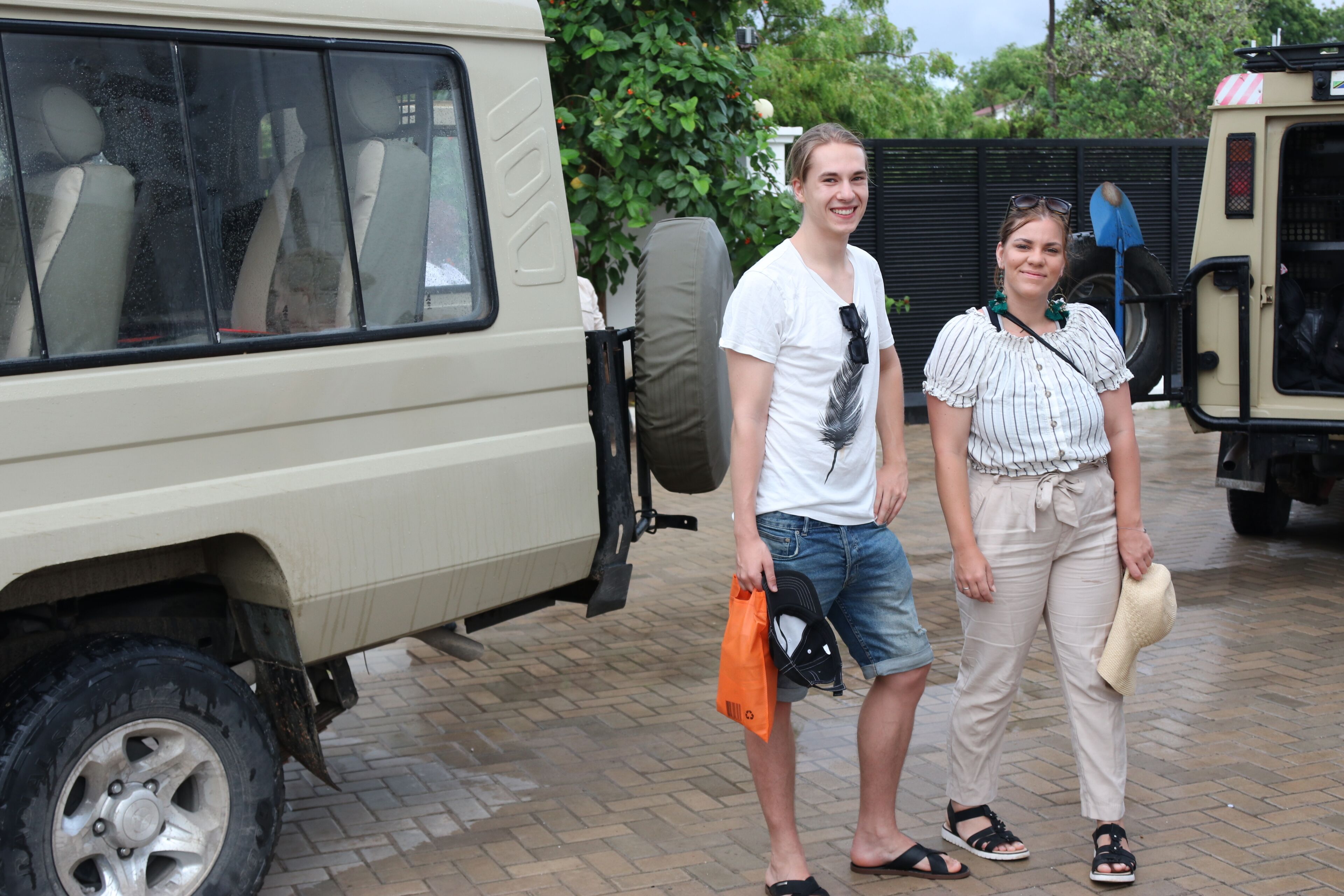 Een beige SUV met een reservewiel op de achterdeur, geparkeerd op een verharde ondergrond.