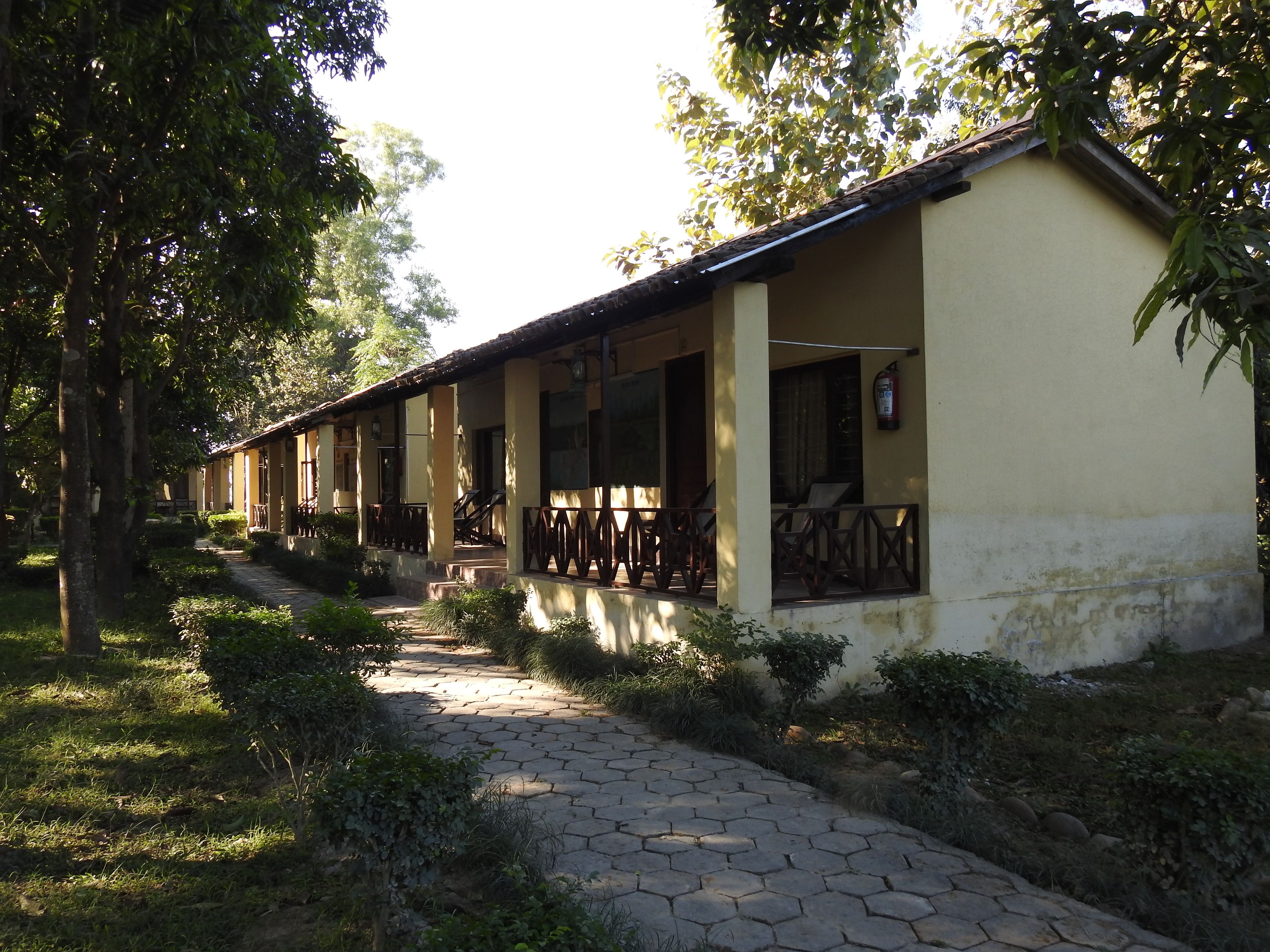 A building with a covered walkway, columns, and a fire extinguisher.