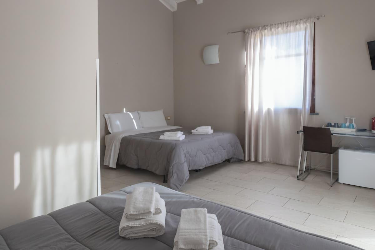 Habitación cuádruple Elite | Ropa de cama de alta calidad y caja de seguridad en la habitación