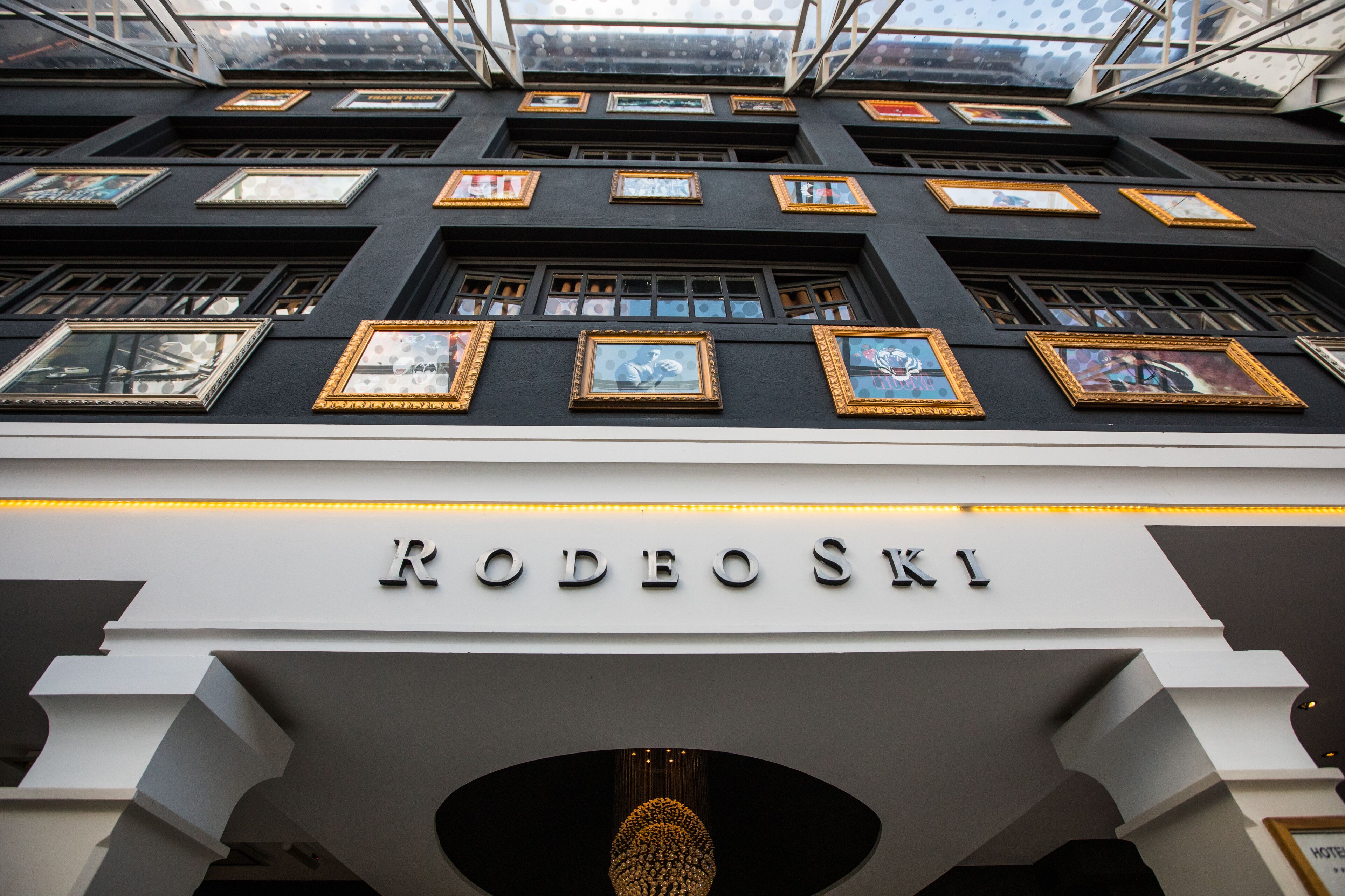 The exterior of the RODEOSKI hotel with multiple framed artworks on the facade and a modern, geometric architectural design.