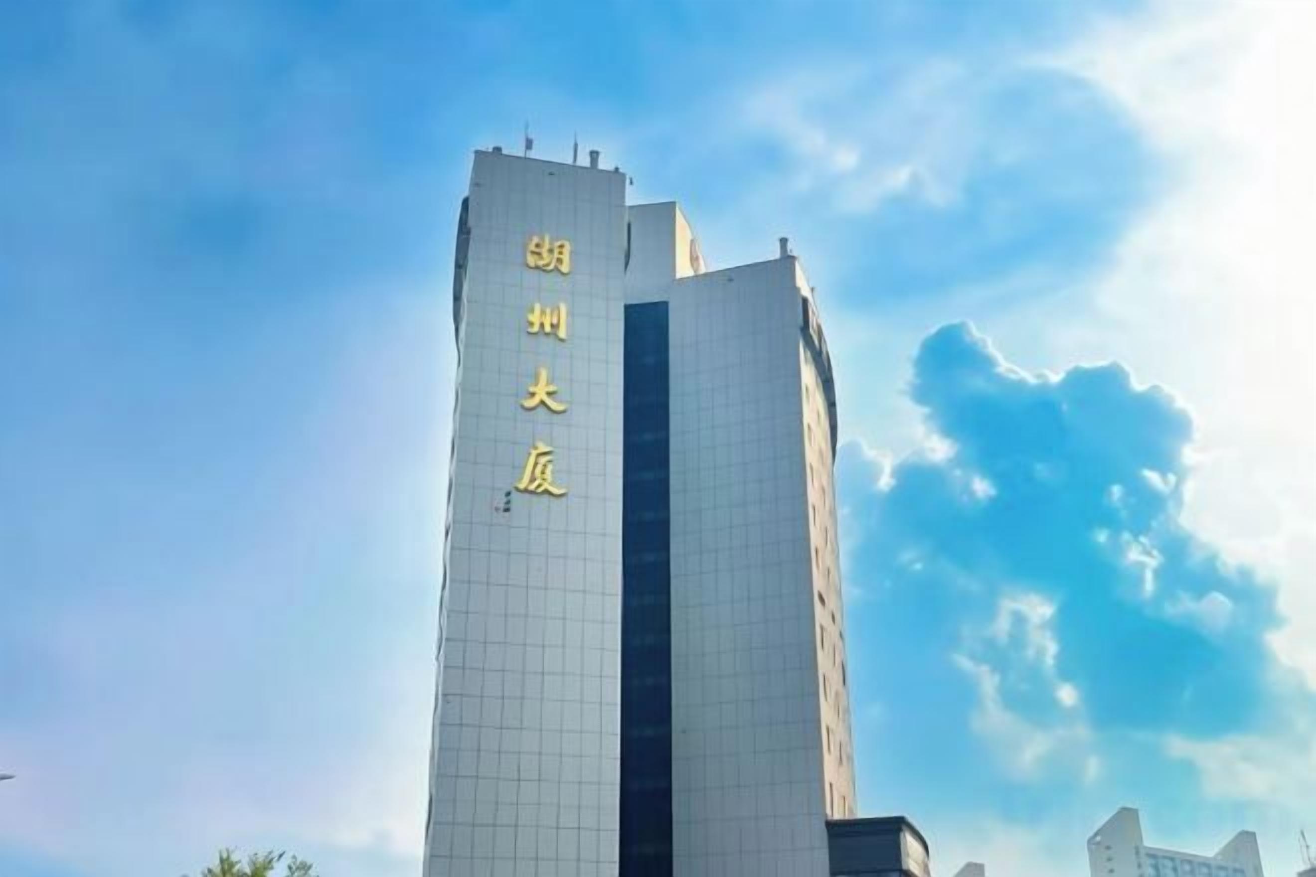 A tall building with a vertical sign.