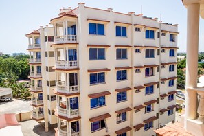 A multi-story building with balconies and windows.