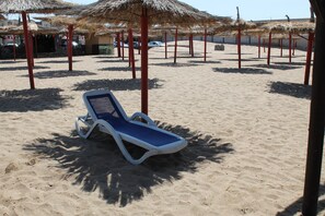 On the beach, beach shuttle, sun-loungers, beach umbrellas