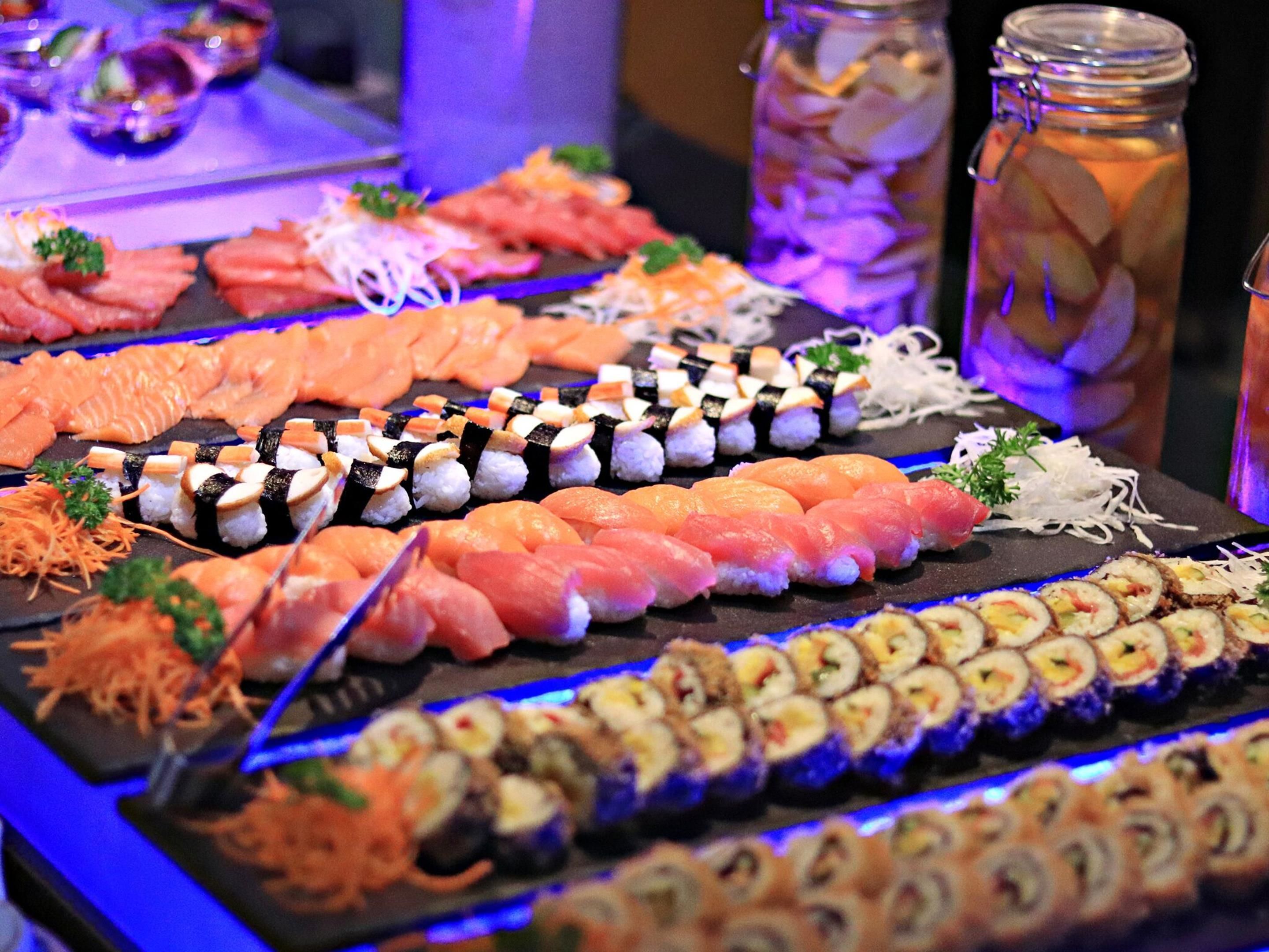 A sushi platter with various types of sushi and sashimi.