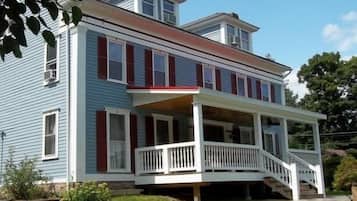 Stroll up to this charming two-story house with a welcoming front porch and beautifully manicured lawn.