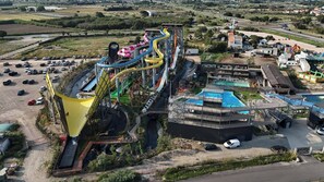 Vue aérienne d’un parc aquatique avec de nombreux toboggans et un grand espace piscine.