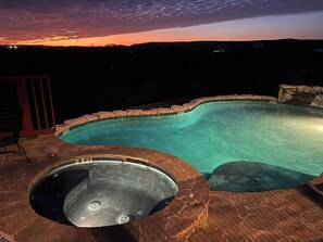 A swimming pool with a stone edge and a hot tub, surrounded by a patio area. - Perfect for Families! Big Patio, Pool/Hot Tub (Burnet)
