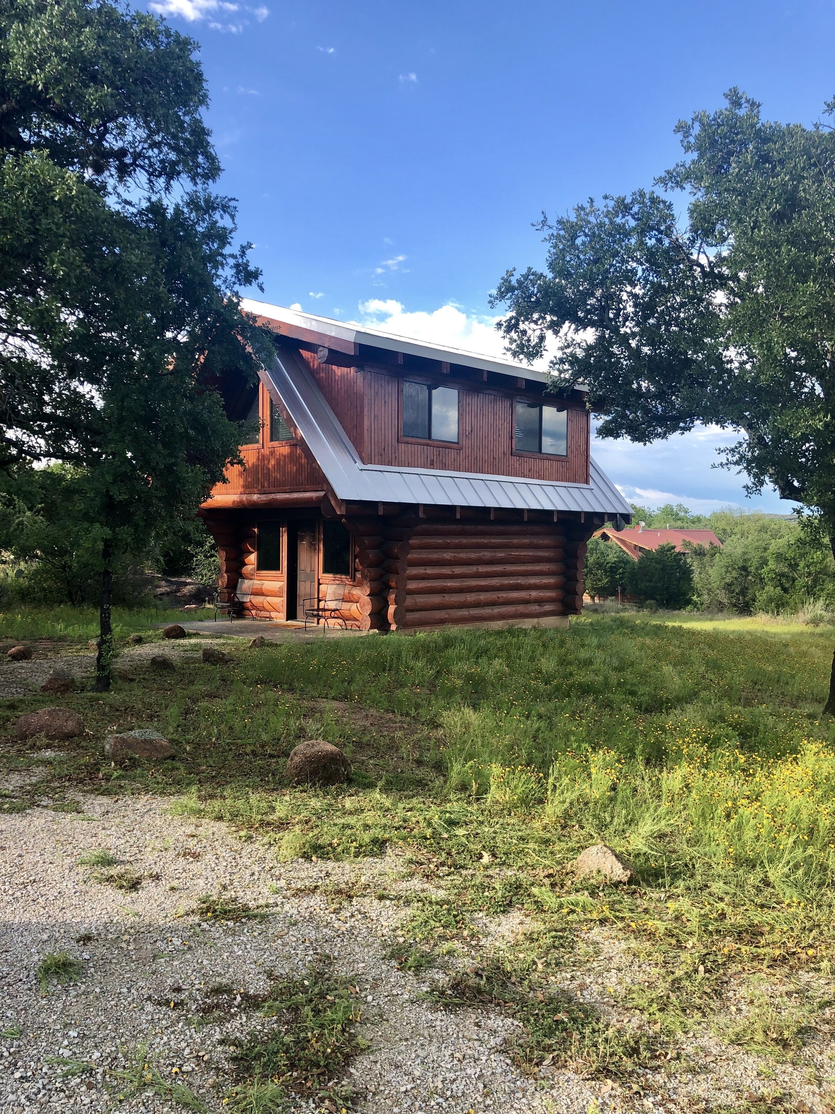 A log cabin with a sloped roof and a small porch.