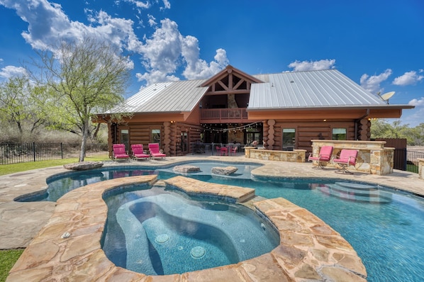 Relax by the pool surrounded by a natural setting and enjoy the view from the cabin's balcony.